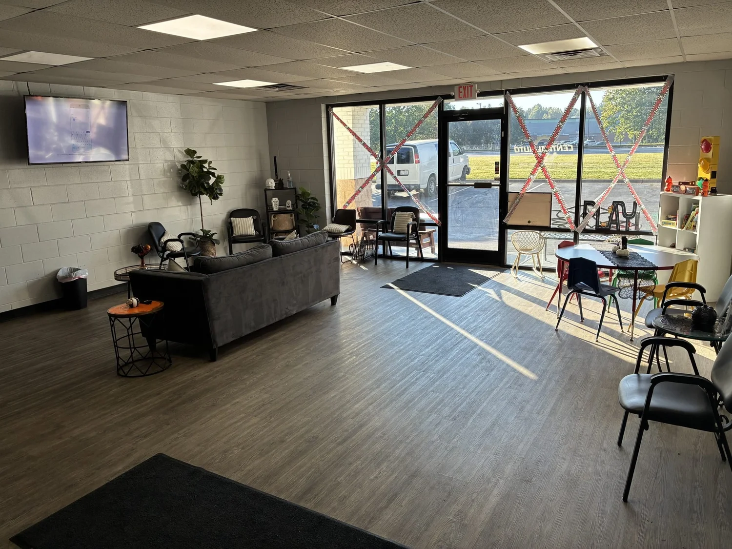 Customer waiting area with a sofa and a wall-mounted TV