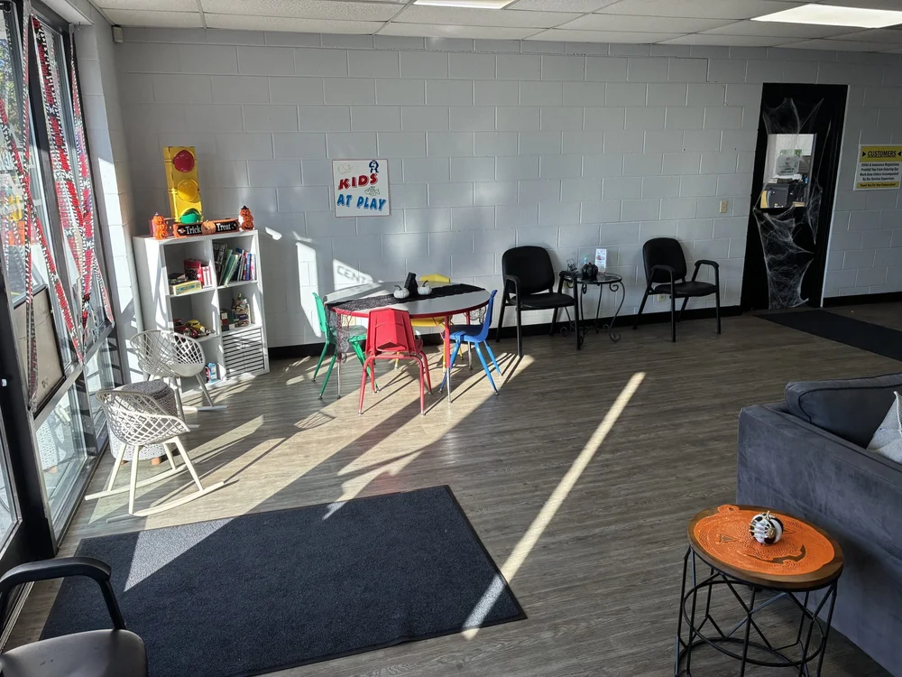 Kids' play area with a small table, chairs and a toy shelf