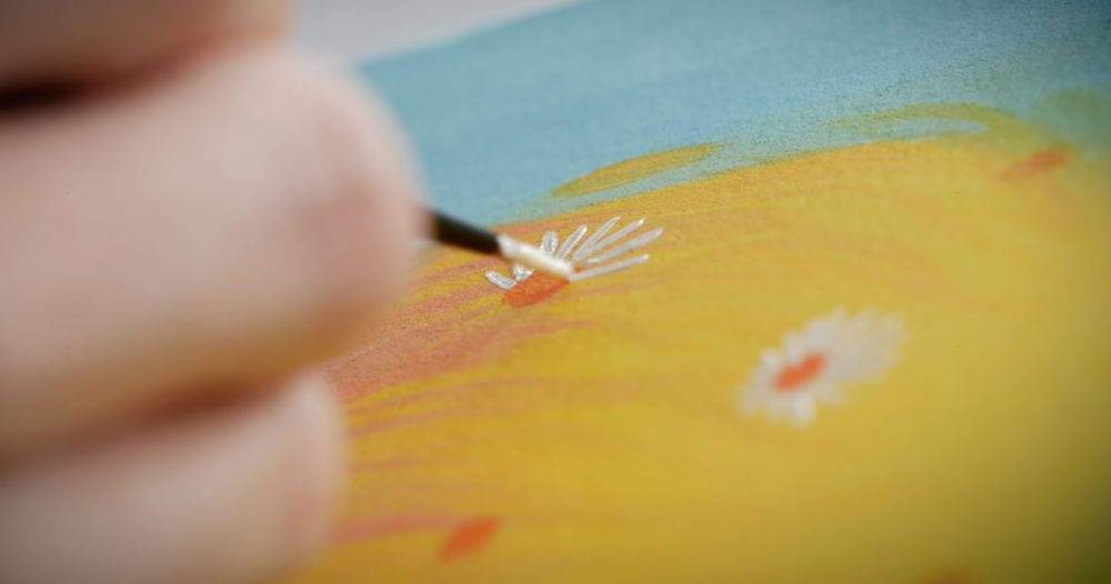 Close-up of a fine brush painting flowers in yellow