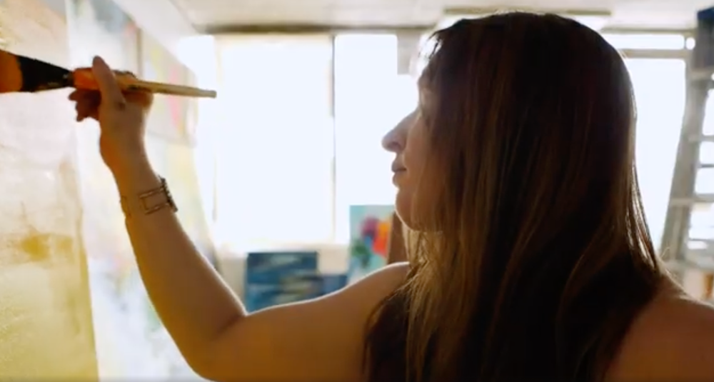 Artist painting in her studio