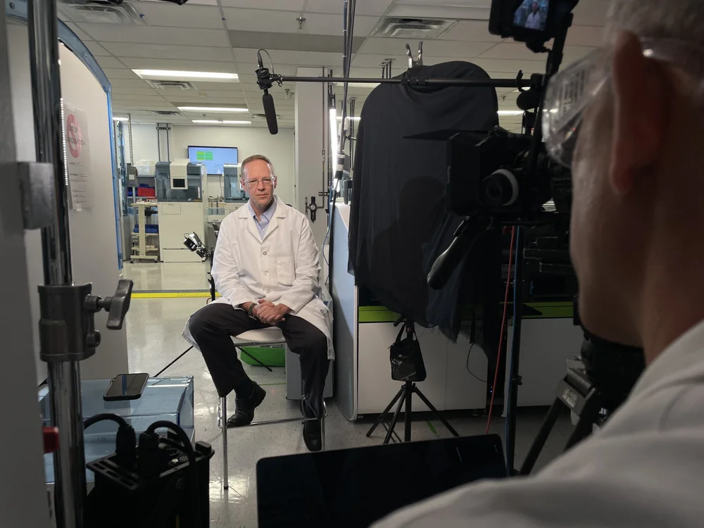 Lab interview setup with lighting and a seated subject