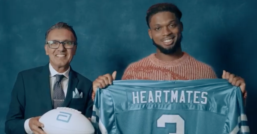 Damar Hamlin and an Abbott physician holding a HeartMates jersey