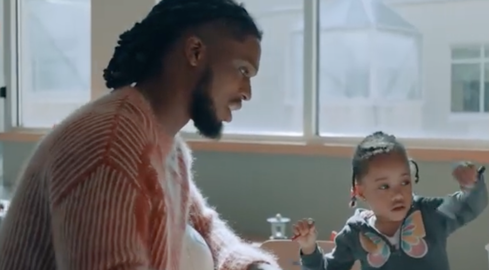 Damar Hamlin playing with a young heart patient at a table