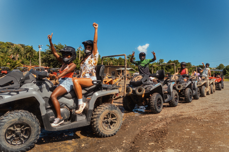 Five ATVs line up in a row as they prepare to depart for a tour