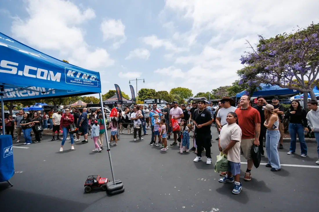 Families, kids and a dog watching the RC crawler course at Rodeo x Rigs
