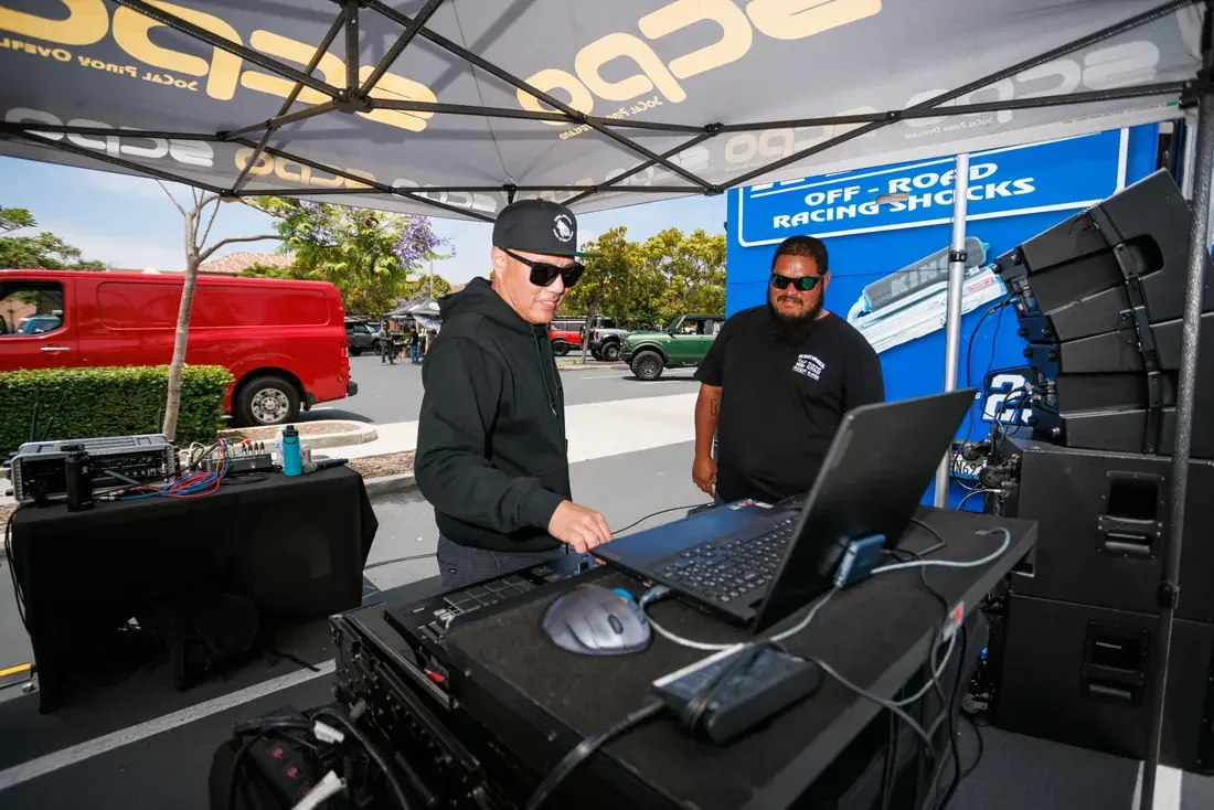 DJ on the decks under the SCPO canopy at a Rodeo x Rigs stop