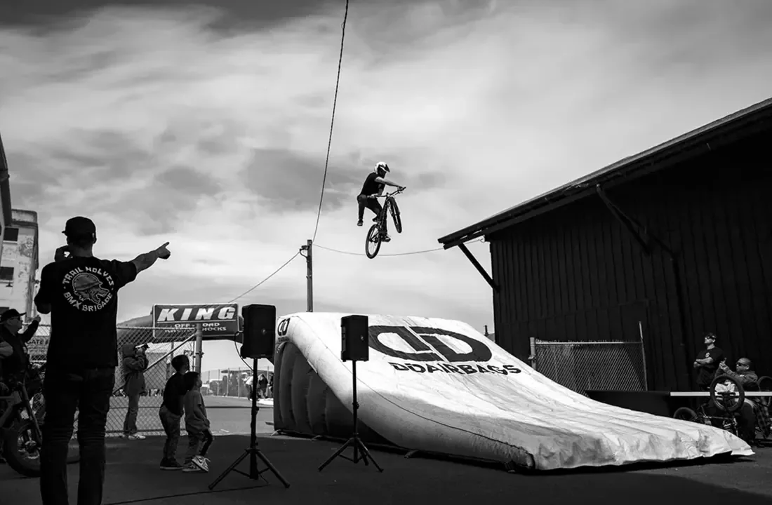 Rider mid-air over the DD Airbags ramp at the Trail Wolves BMX Brigade demo