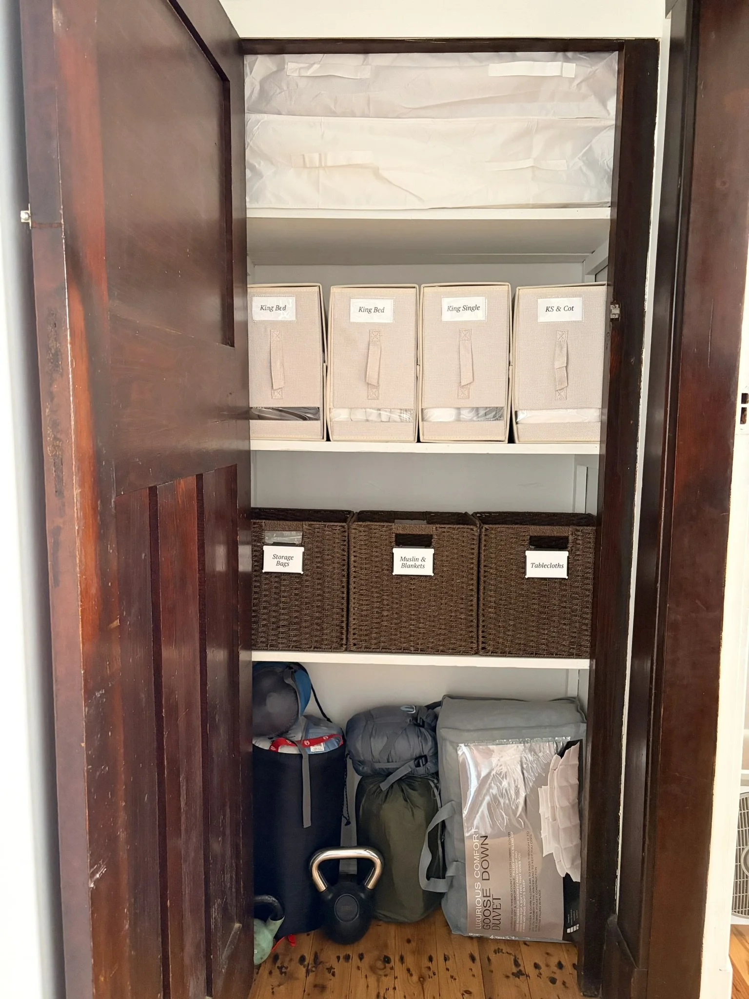 Organised linen cupboard after