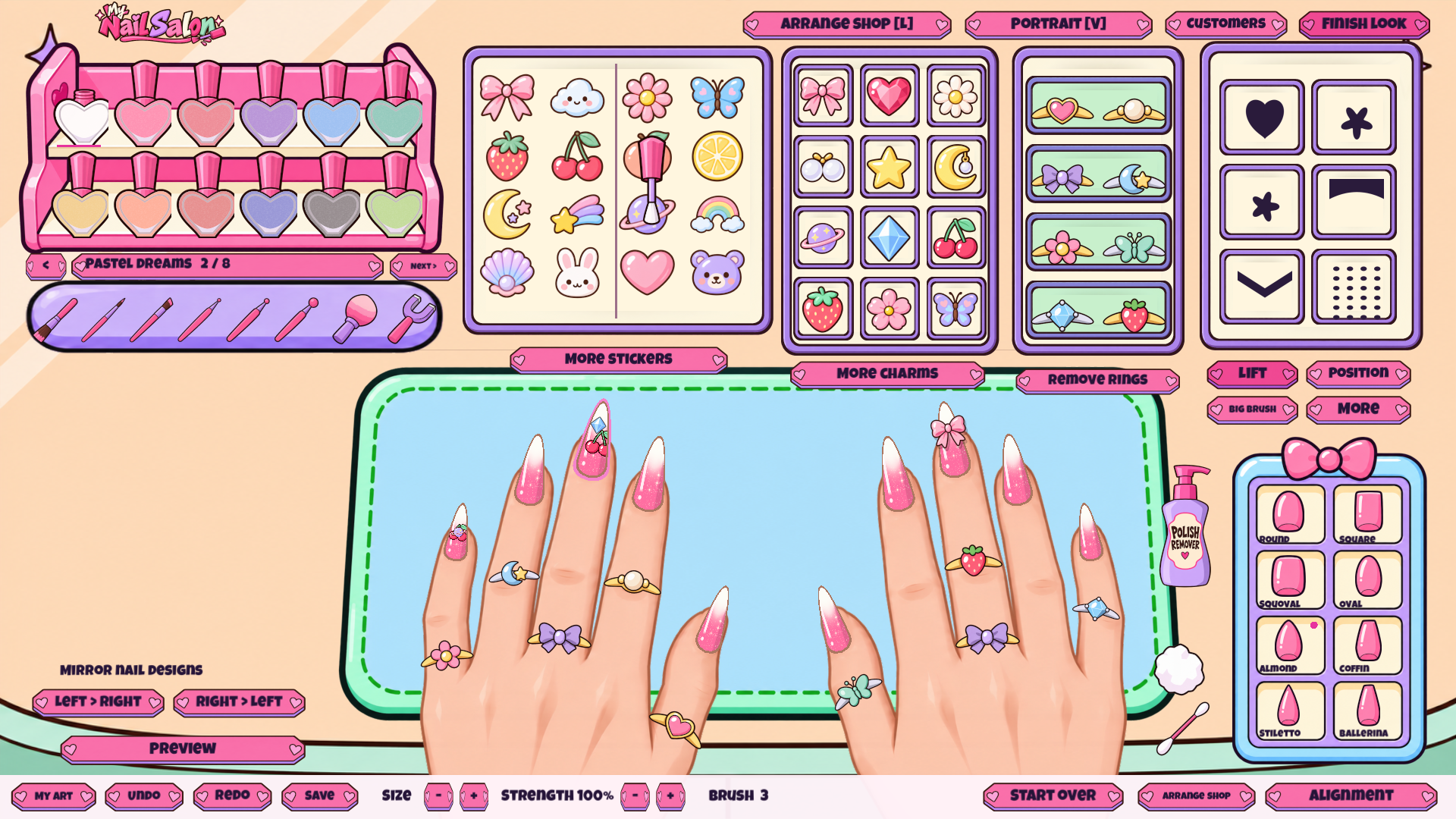 A pink nail design with glitter, charms and rings.