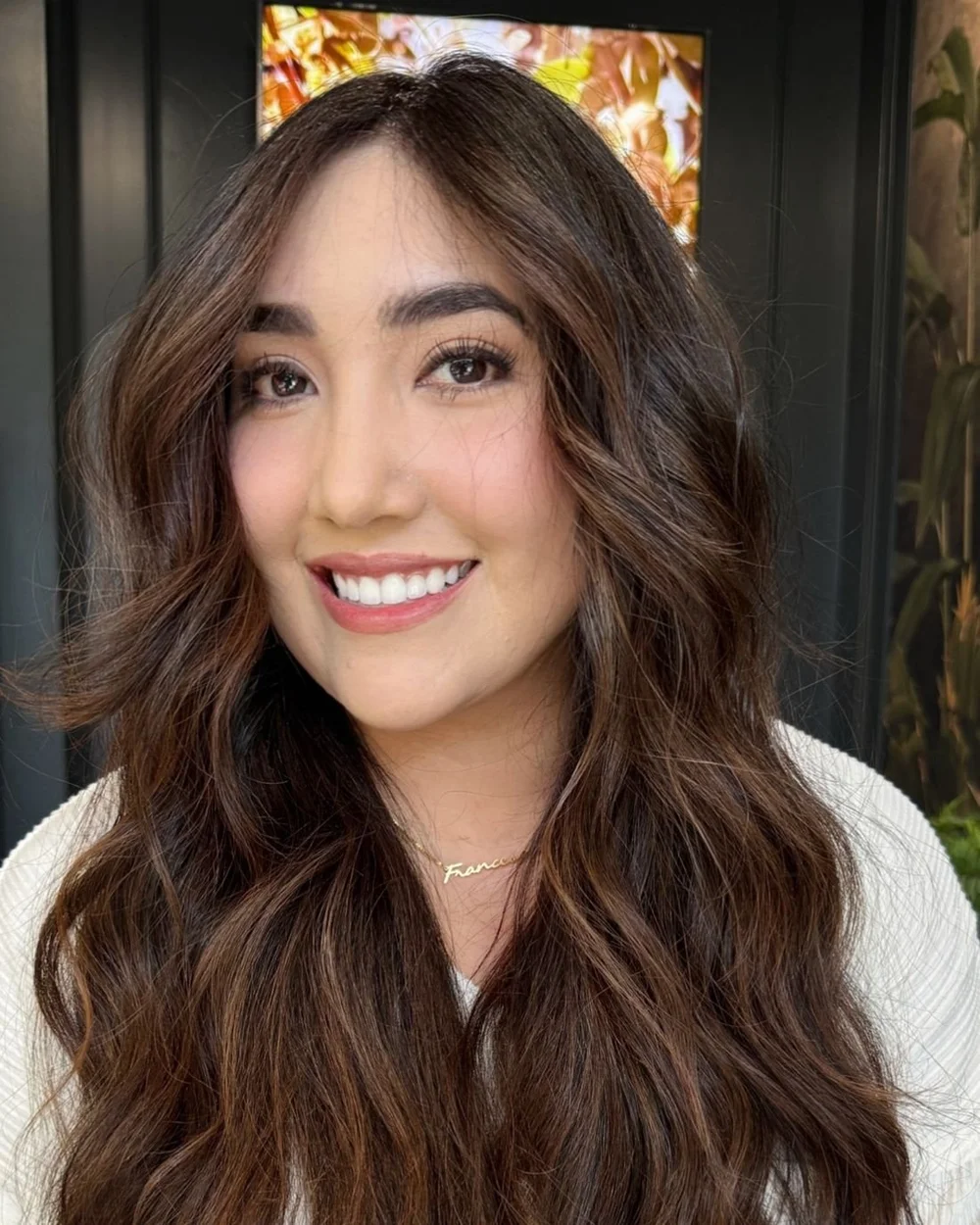Guest with long brunette balayage in soft waves, finished at Alfredo James Hair Design in San Antonio