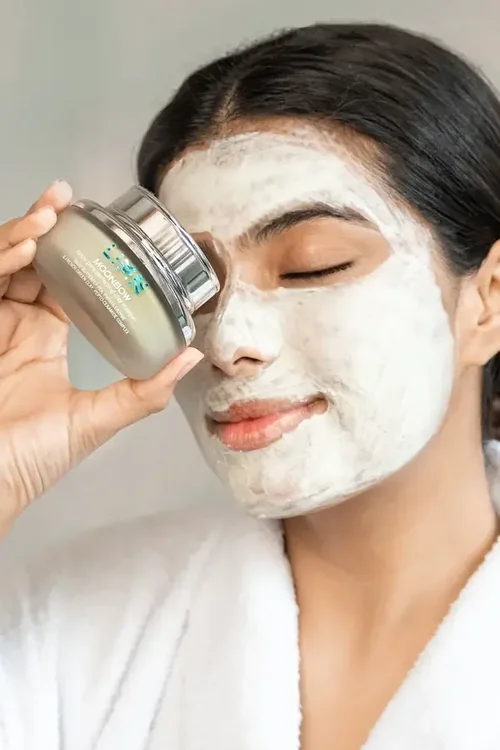 Model in a clay mask holding LIMN Moonbow