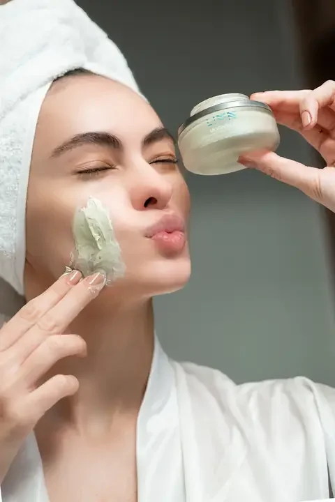 Model in a hair towel applying LIMN Moonbow