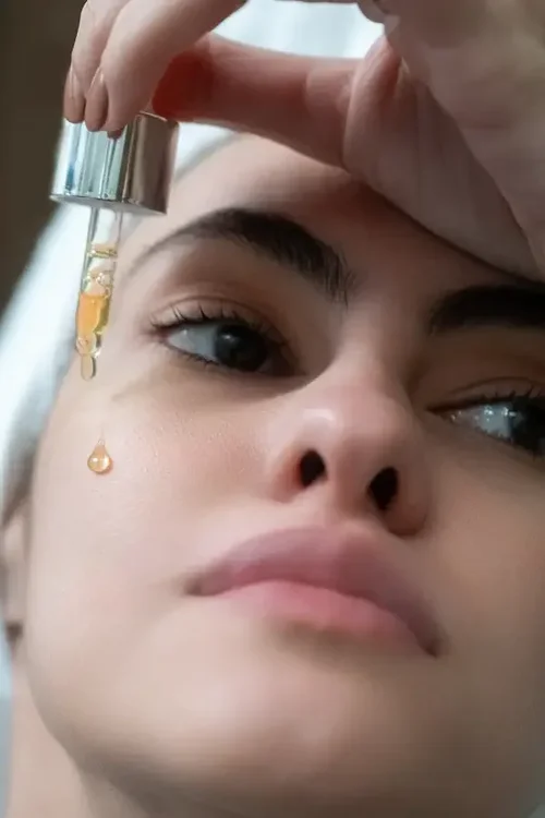 A drop of LIMN serum falling onto skin