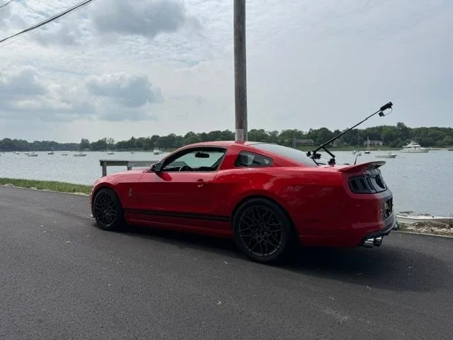 The red 2014 Shelby GT500 beside the water