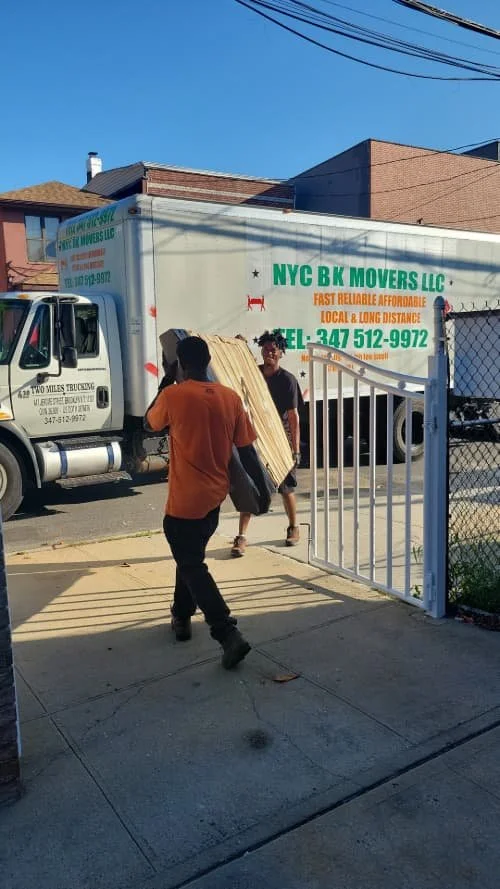 NYC Brooklyn Movers LLC movers with a moving truck in Fort Greene
