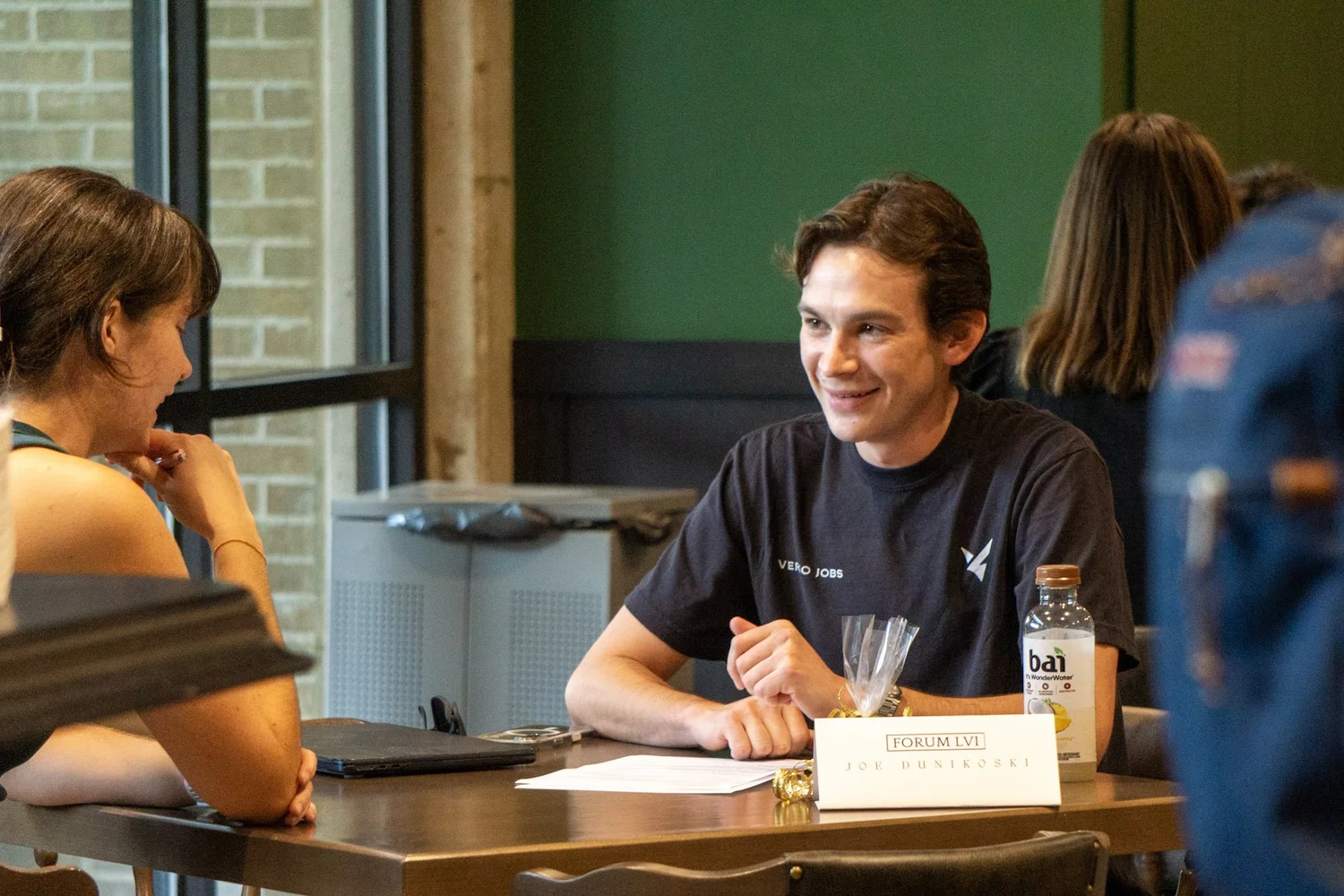 Joe Dunikoski talking with a student
