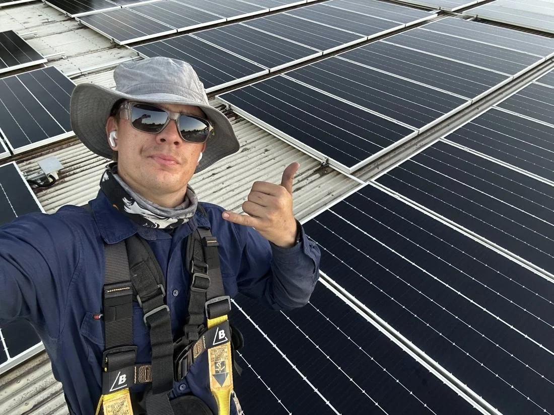 Will Richter, qualified electrician and owner of SunWise, on a solar roof