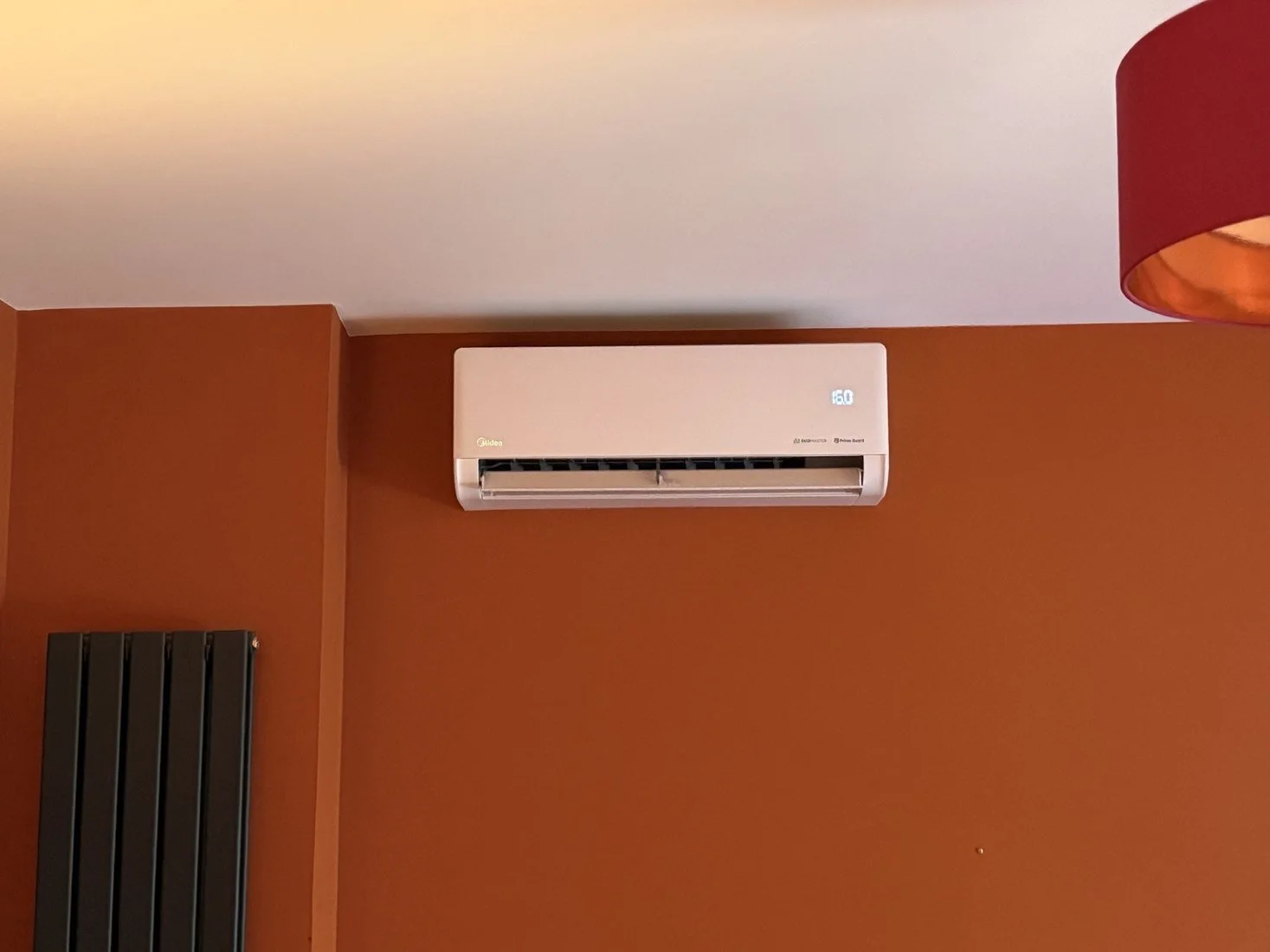 White air conditioning unit on a warm-toned feature wall