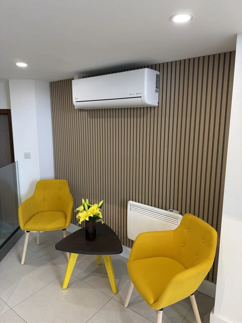 Wall-mounted air conditioning unit on a timber slat feature wall