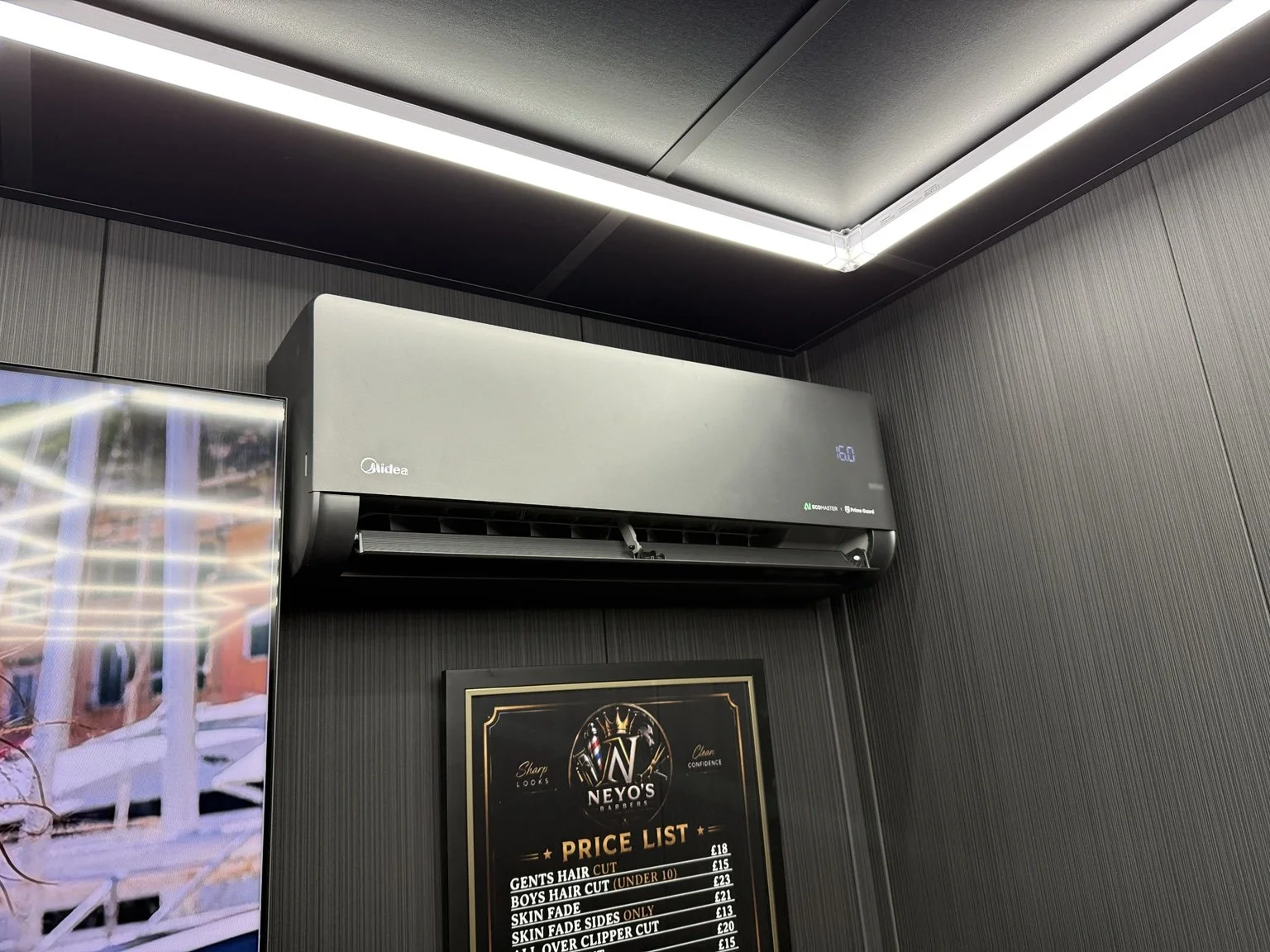 Black 3.5kW Midea Solstice indoor unit installed at Neyo’s Barbers