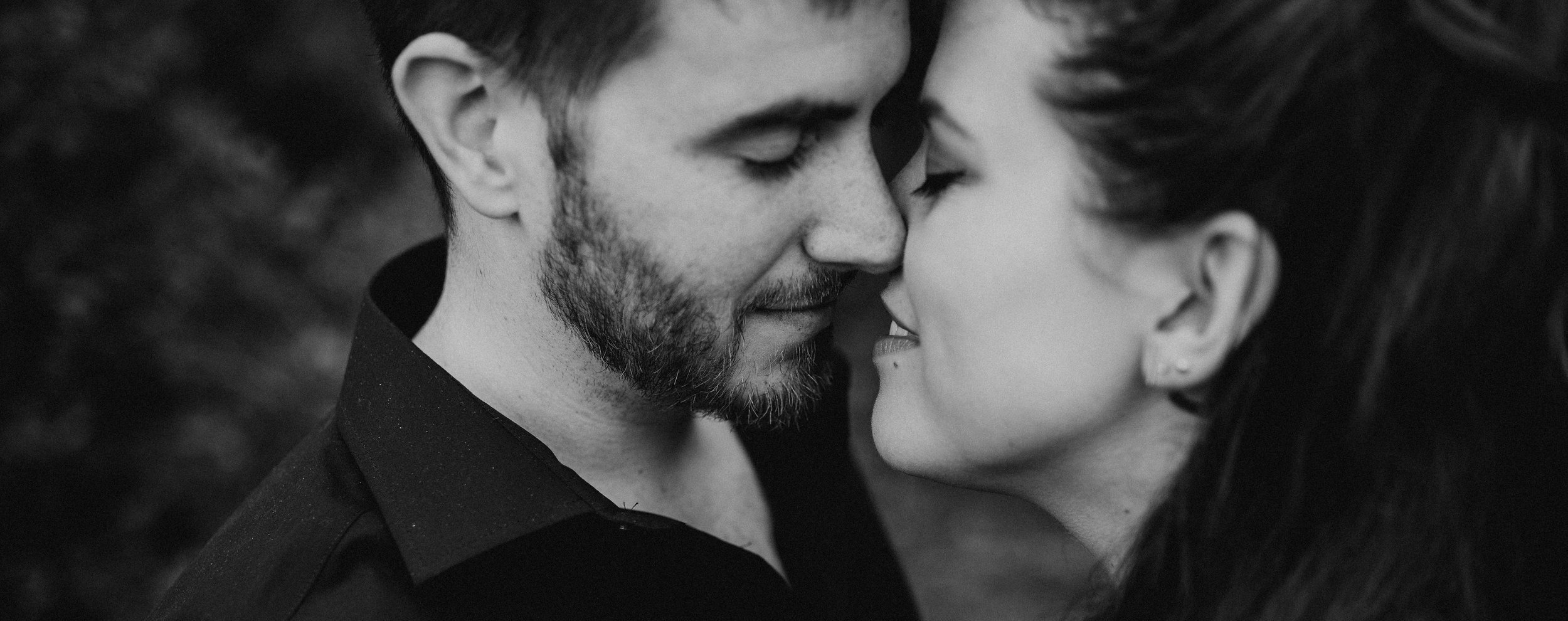 Black and white close-up of Robert and Michelle leaning in with eyes closed, intimate moment for himVher couples lifestyle brand