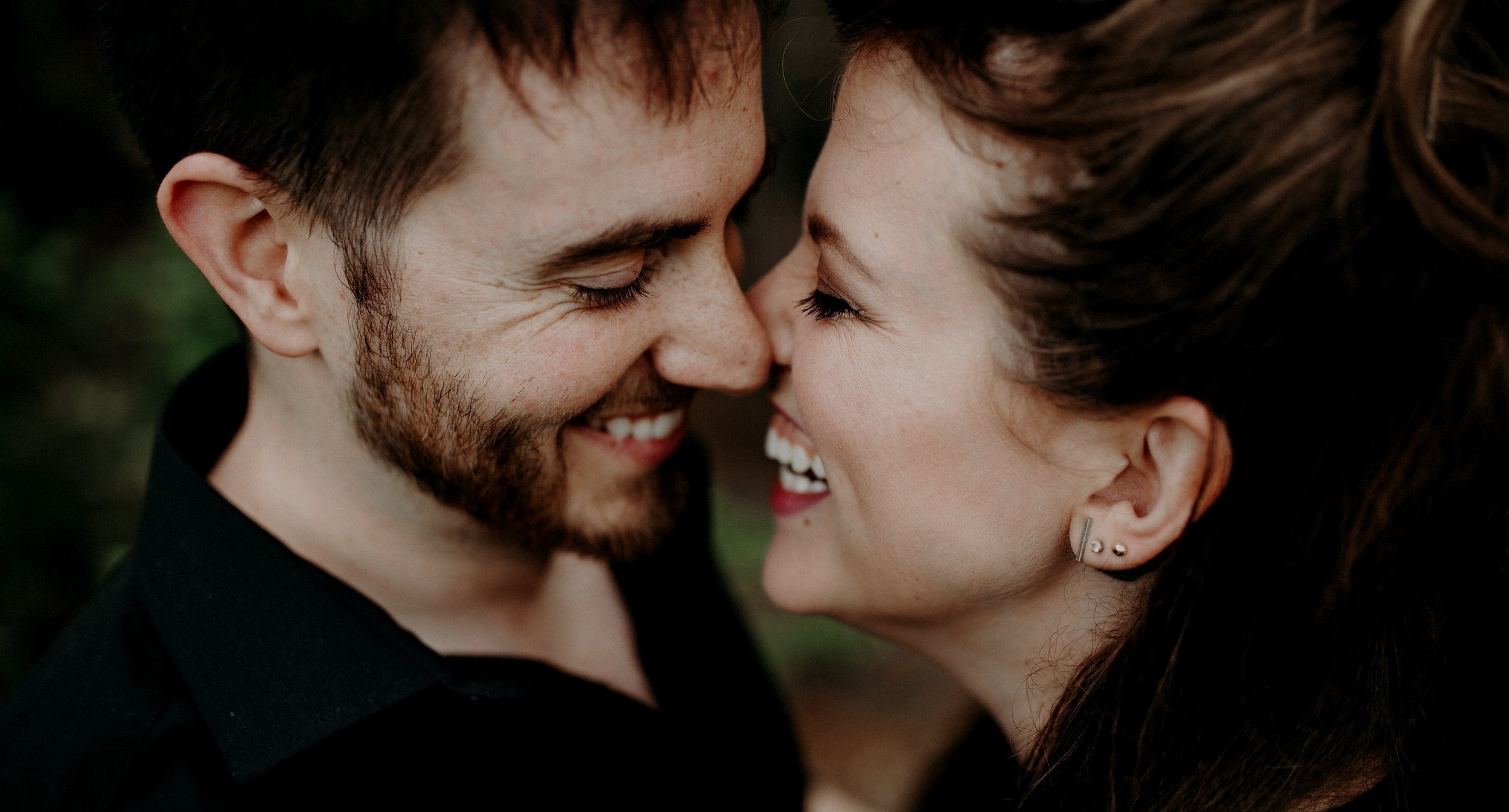 Couple laughing close together, joyful intimate moment, lifestyle photo of himVher brand founders Robert and Michelle