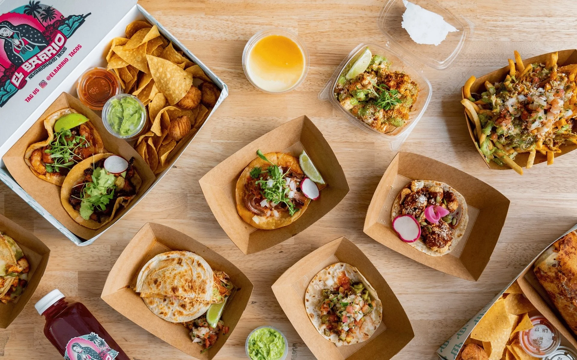 Tacos, chips, guacamole and sides with El Barrio Neighborhood Tacos packaging