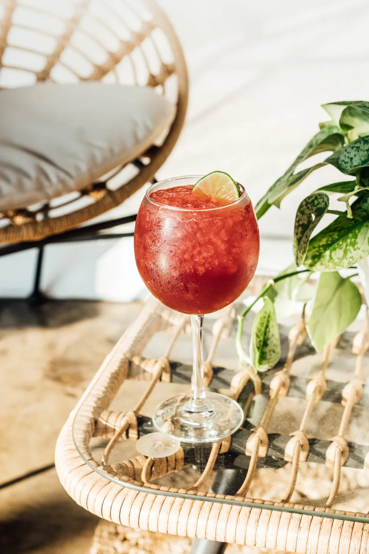 A red cocktail beside the seating at El Barrio Cantina