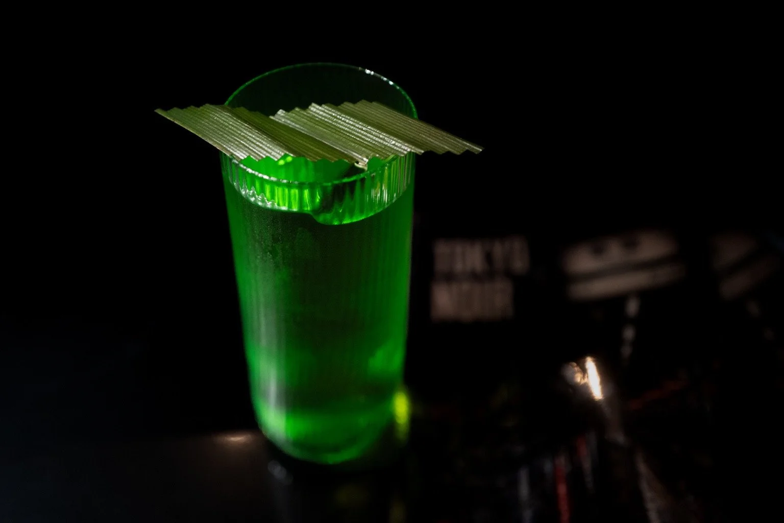 Green highball with a leaf garnish