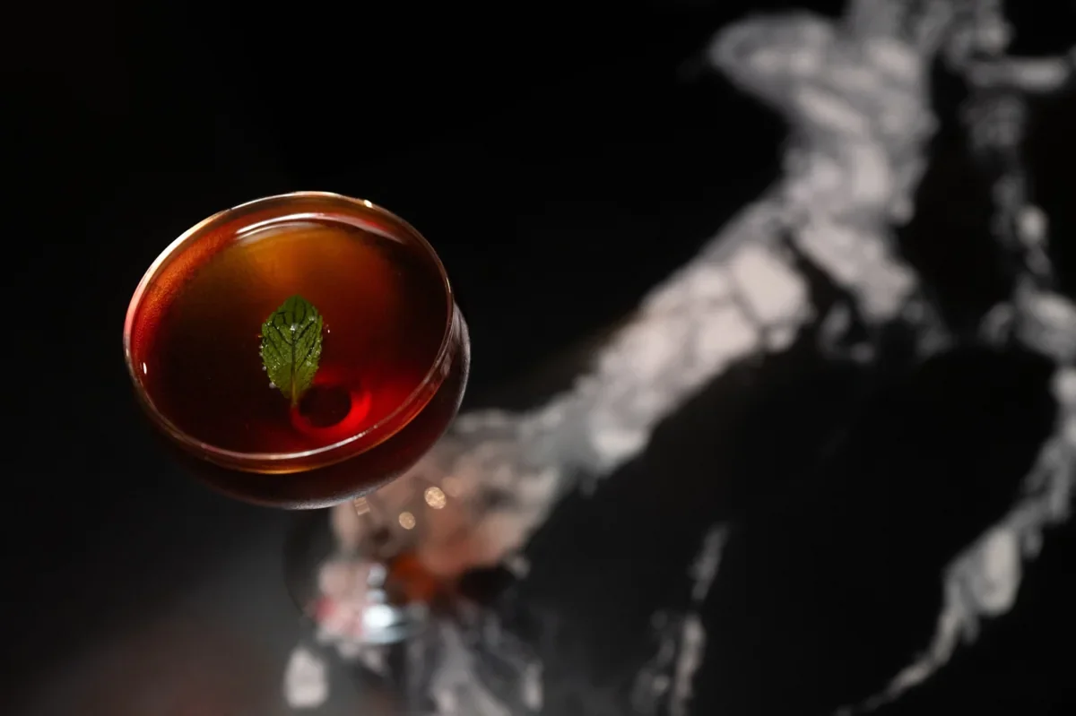 A red cocktail in a coupe glass at Tokyo Noir
