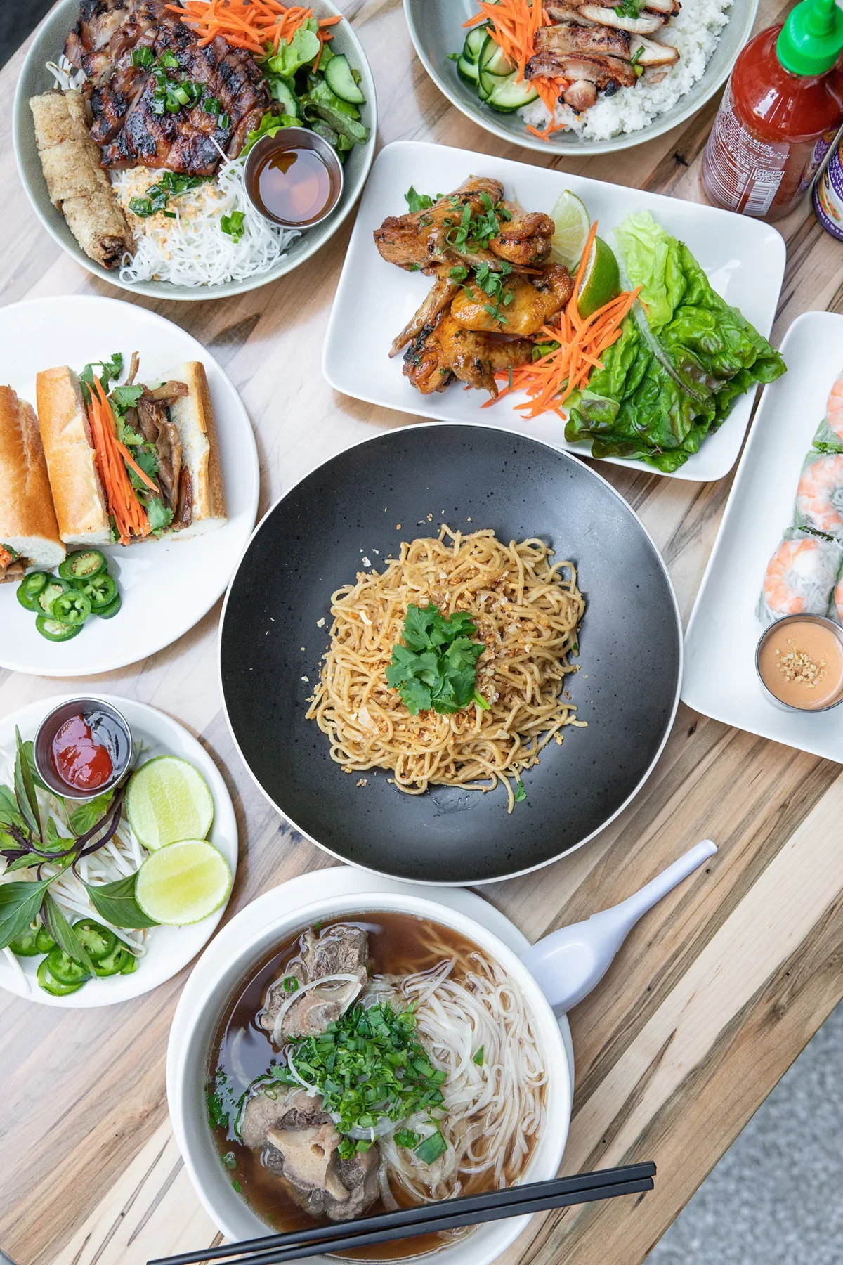 Phorage pho, banh mi and dishes on a table