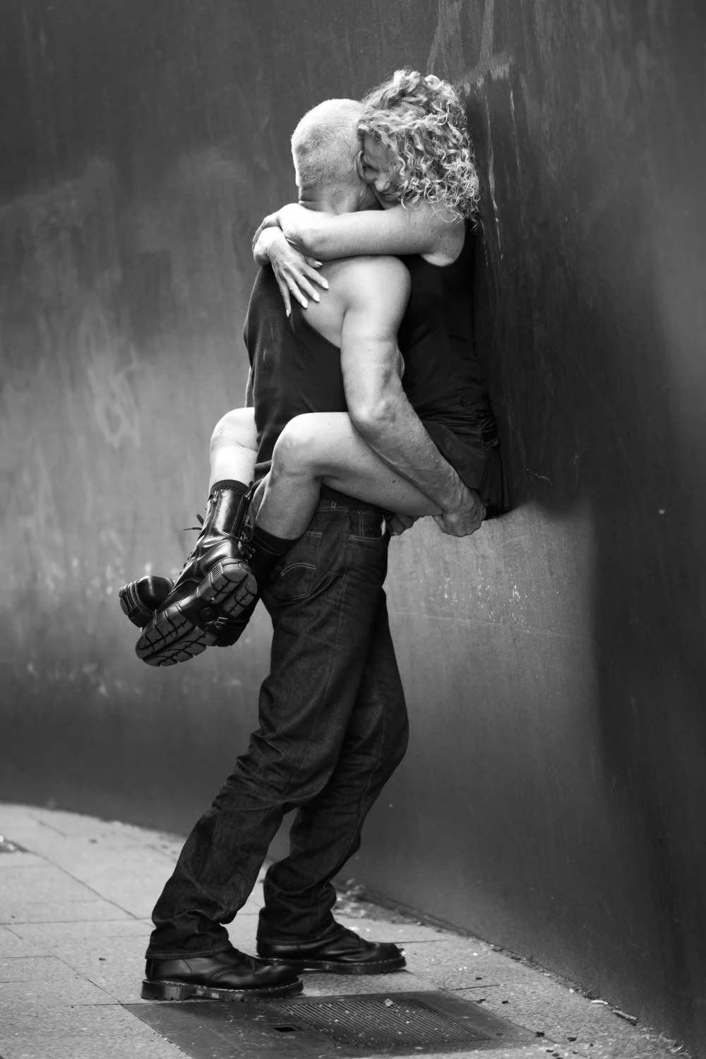 Chrisanna wrapped around Mark against a steel wall