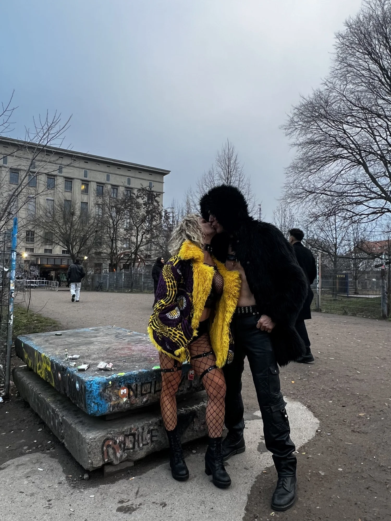 Chrisanna and Mark kissing outside Berghain in Berlin at dusk