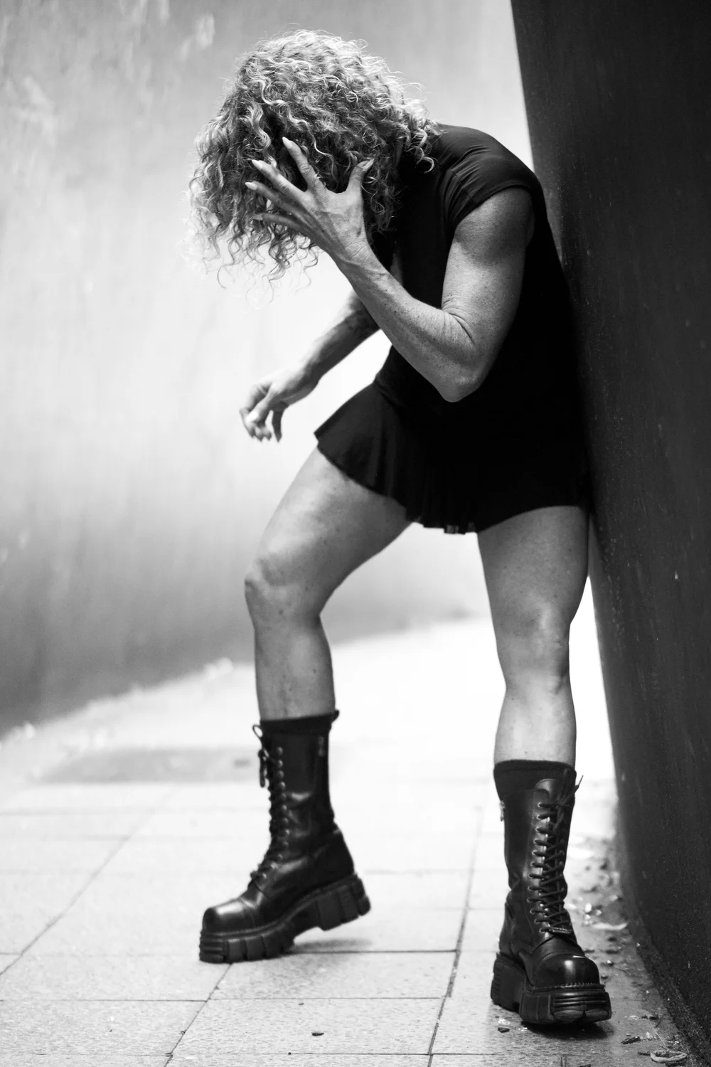 Chrisanna gripping her head against a steel wall