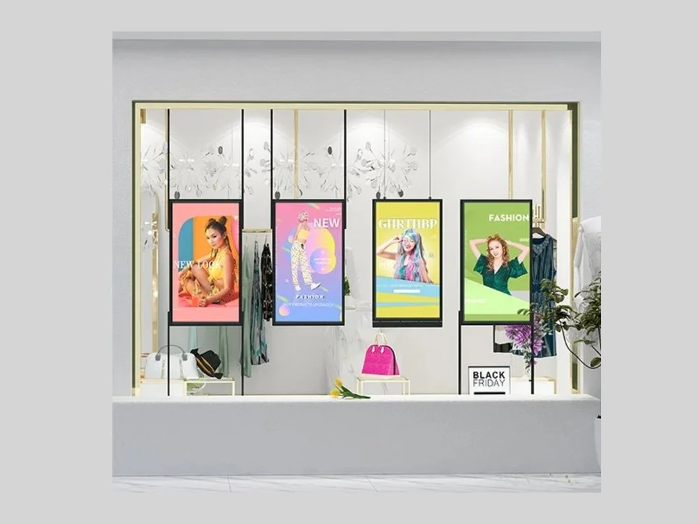 LCD window poster displays in a fashion shopfront window showing seasonal campaigns