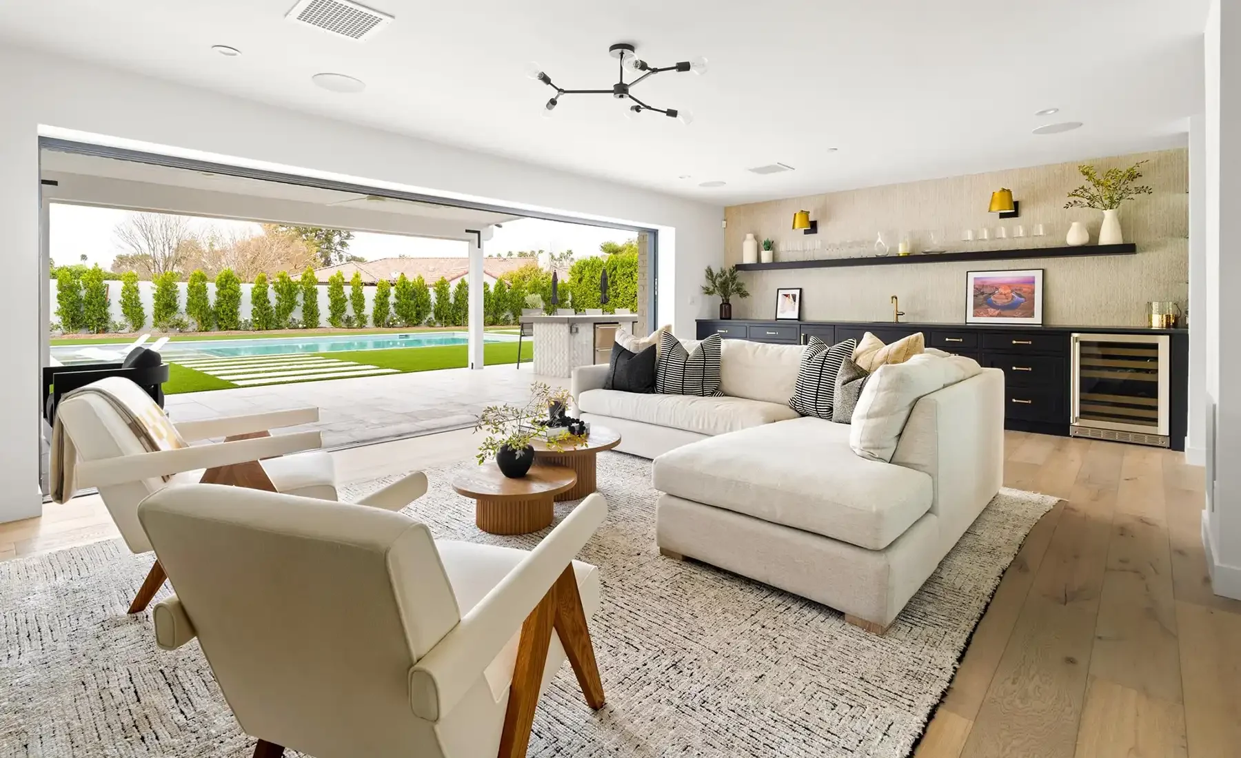 Phoenix living room opening through large sliding doors to a poolside patio
