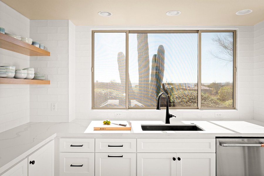 Finished full-service interior design kitchen with layered lighting, cabinetry, countertops, and coordinated finishes
