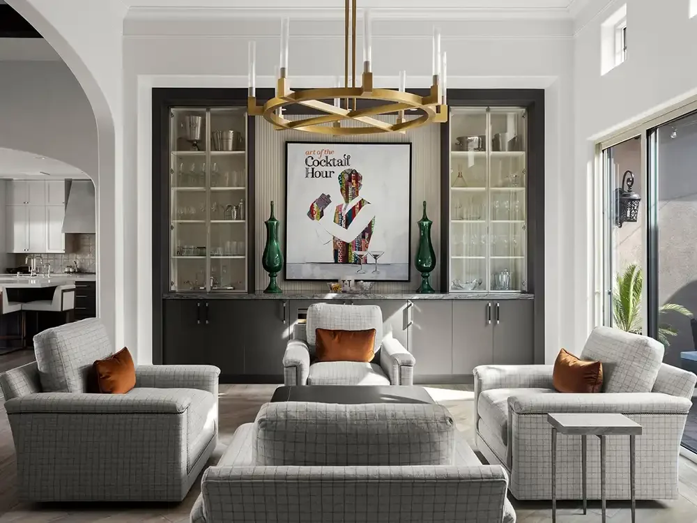 Residential living room with coordinated furnishings, architectural details, and custom cabinetry