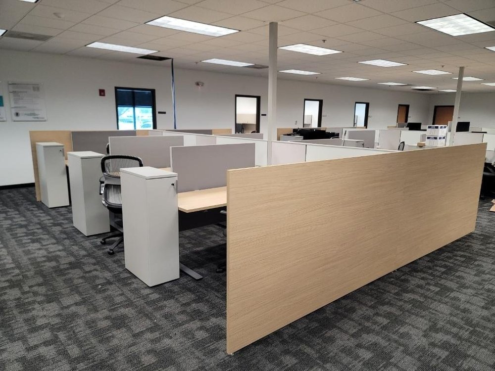 Rows of installed workstations, task seating, and storage in a commercial office