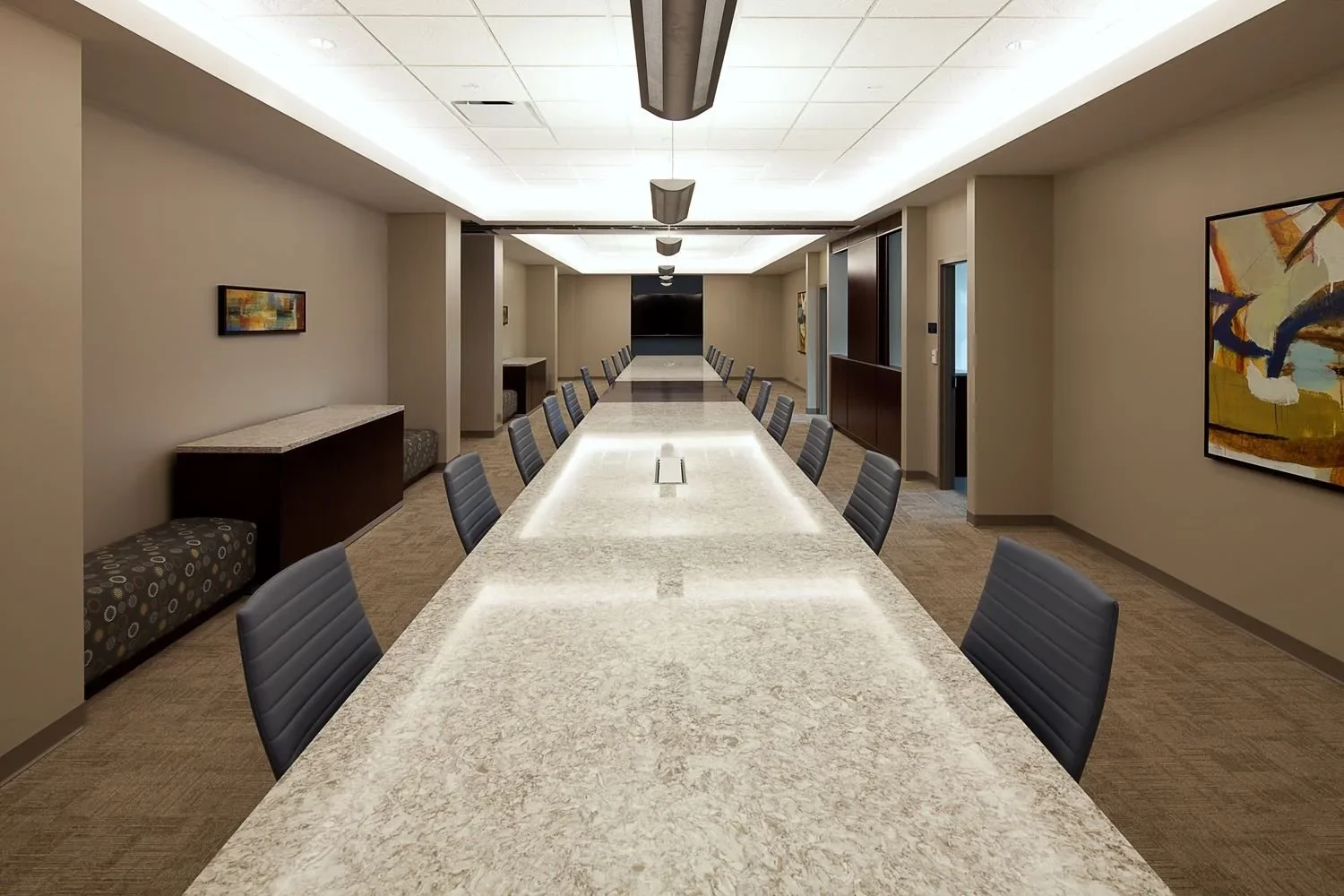 Long conference table with seating and credenzas in a commercial interior