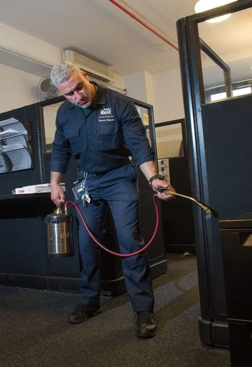 A Pest at Rest commercial applicator treating an office