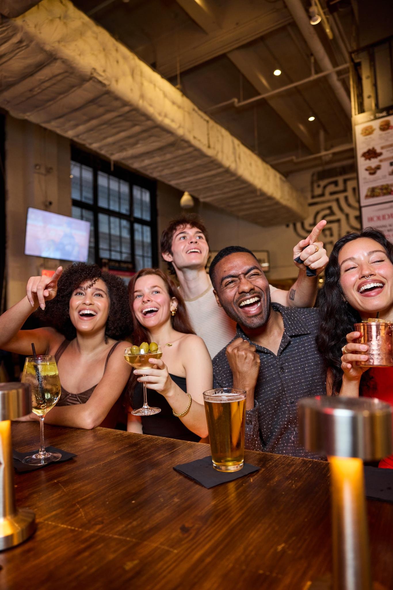 Multiple HD TVs showing live sports broadcasts at Vanderbilt Bar & Grill in Midtown