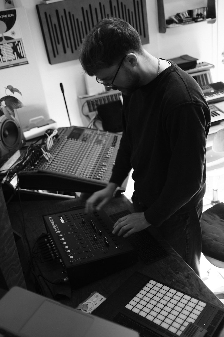 Black-and-white studio photograph of work at the mixing controller