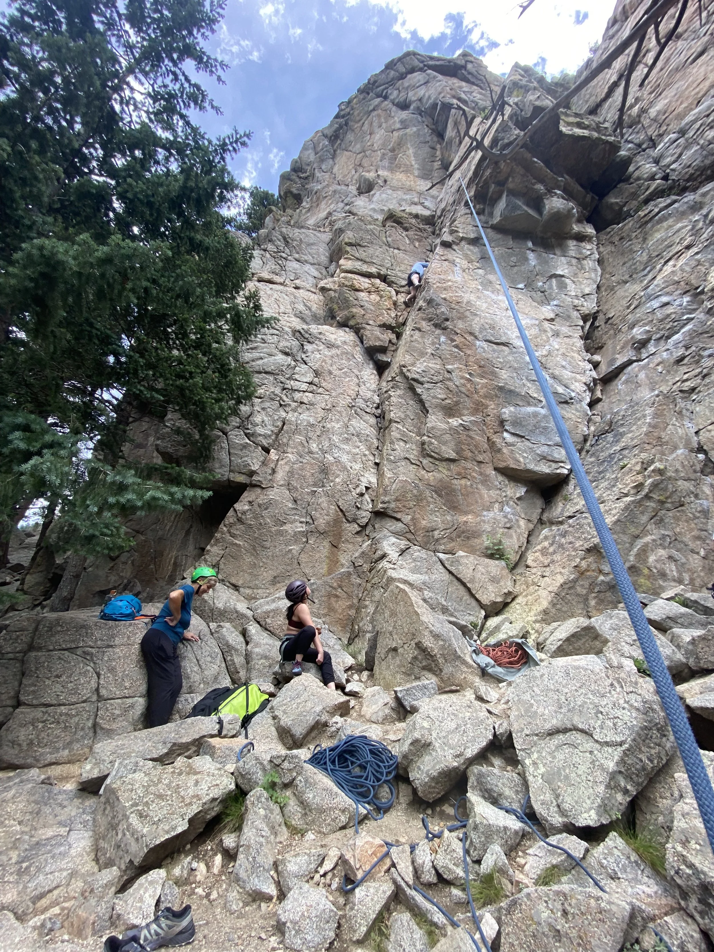 Climbers and a guide at the base of a granite crag in Boulder Canyon