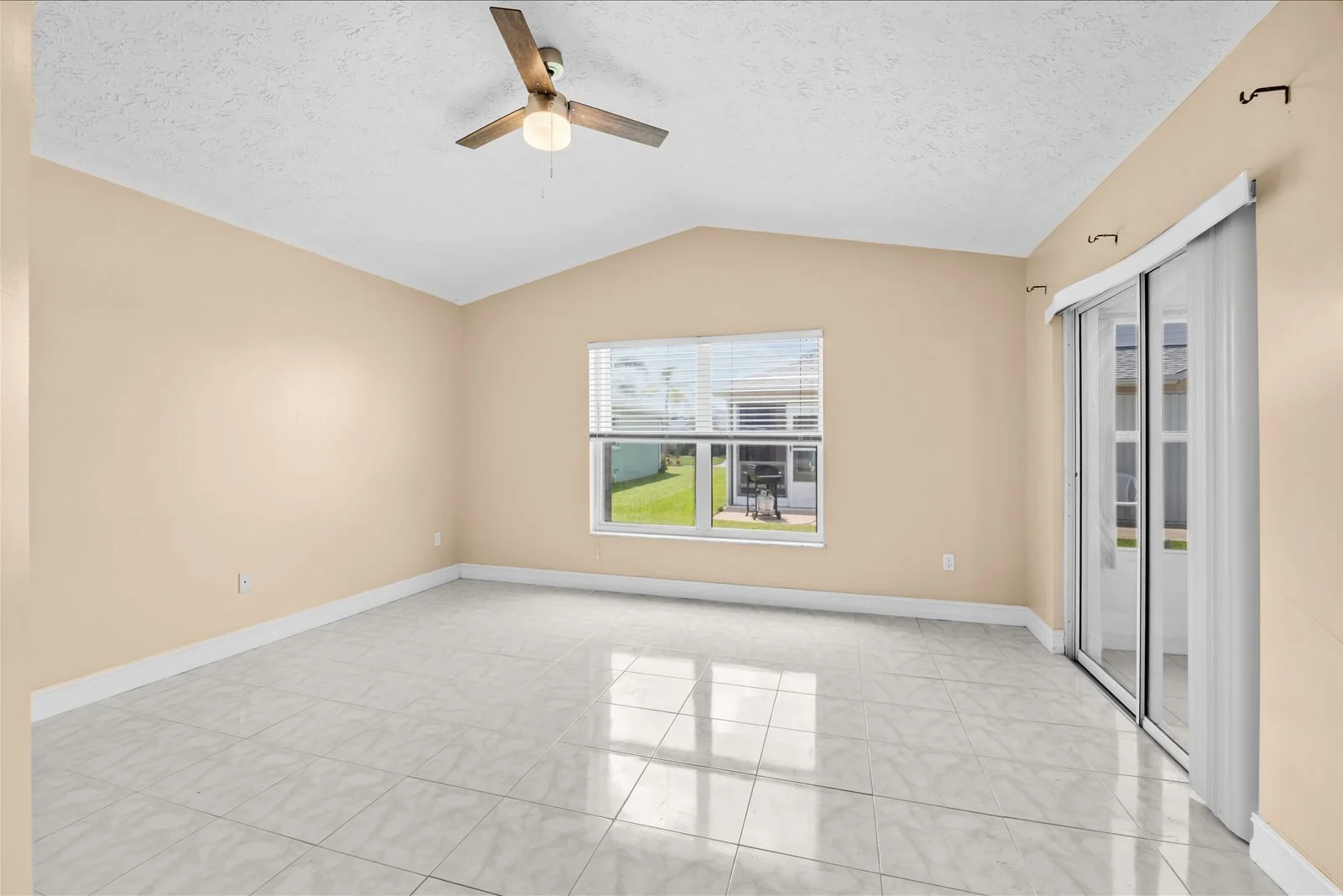 Primary bedroom with vaulted ceiling and walk-in closet access