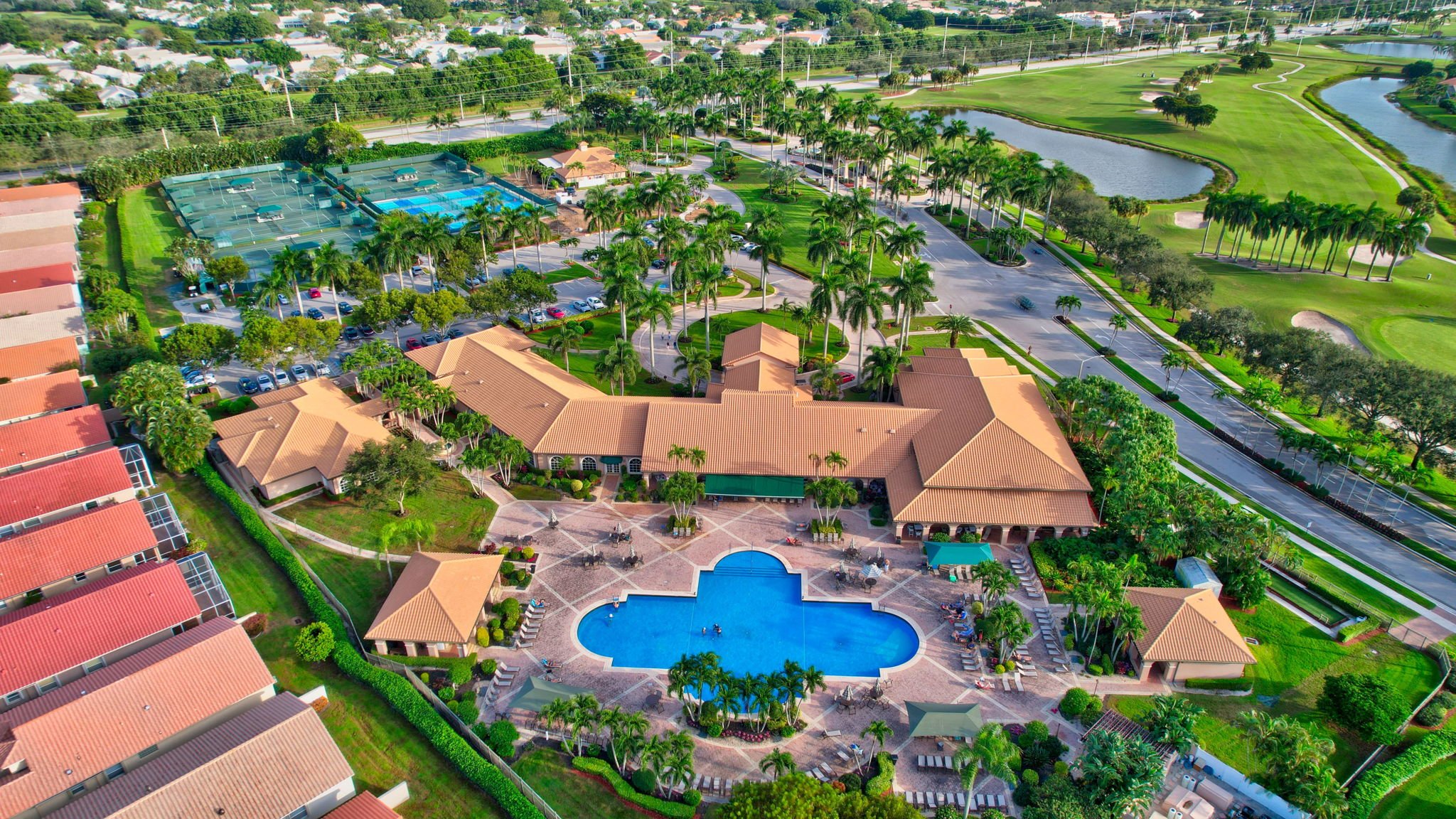 Aerial of clubhouse, pool, and golf course