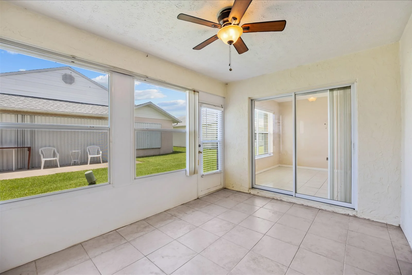 Enclosed Florida room with backyard view