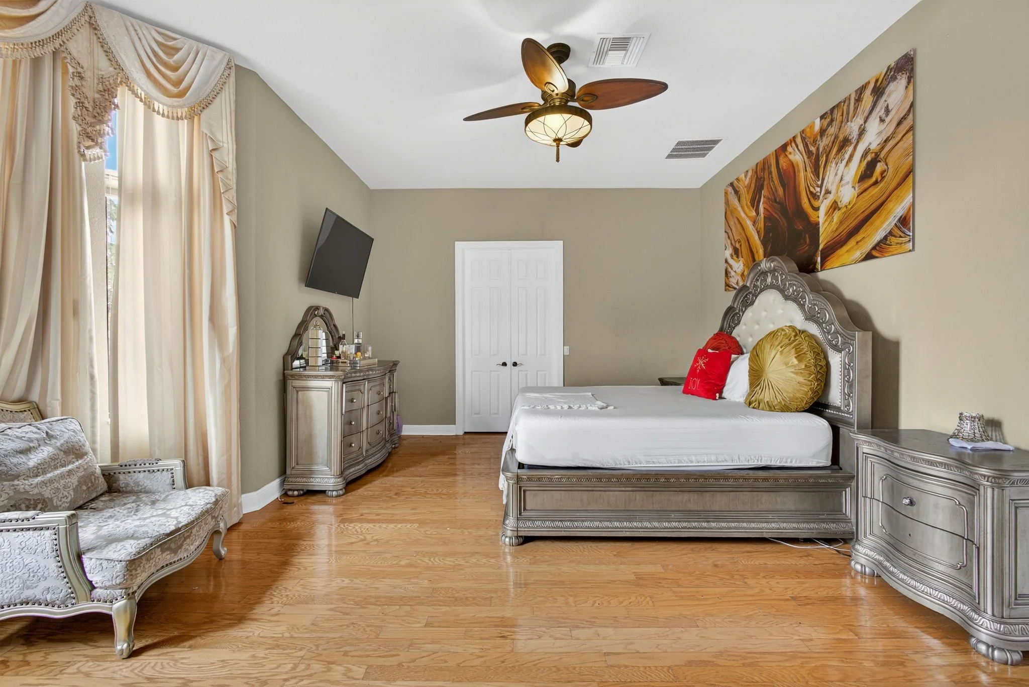 Primary bedroom with tufted headboard