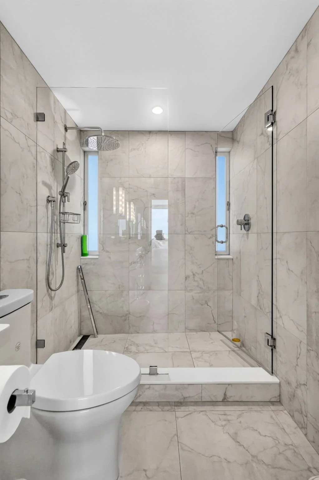Primary bathroom — rainfall shower and marble tile