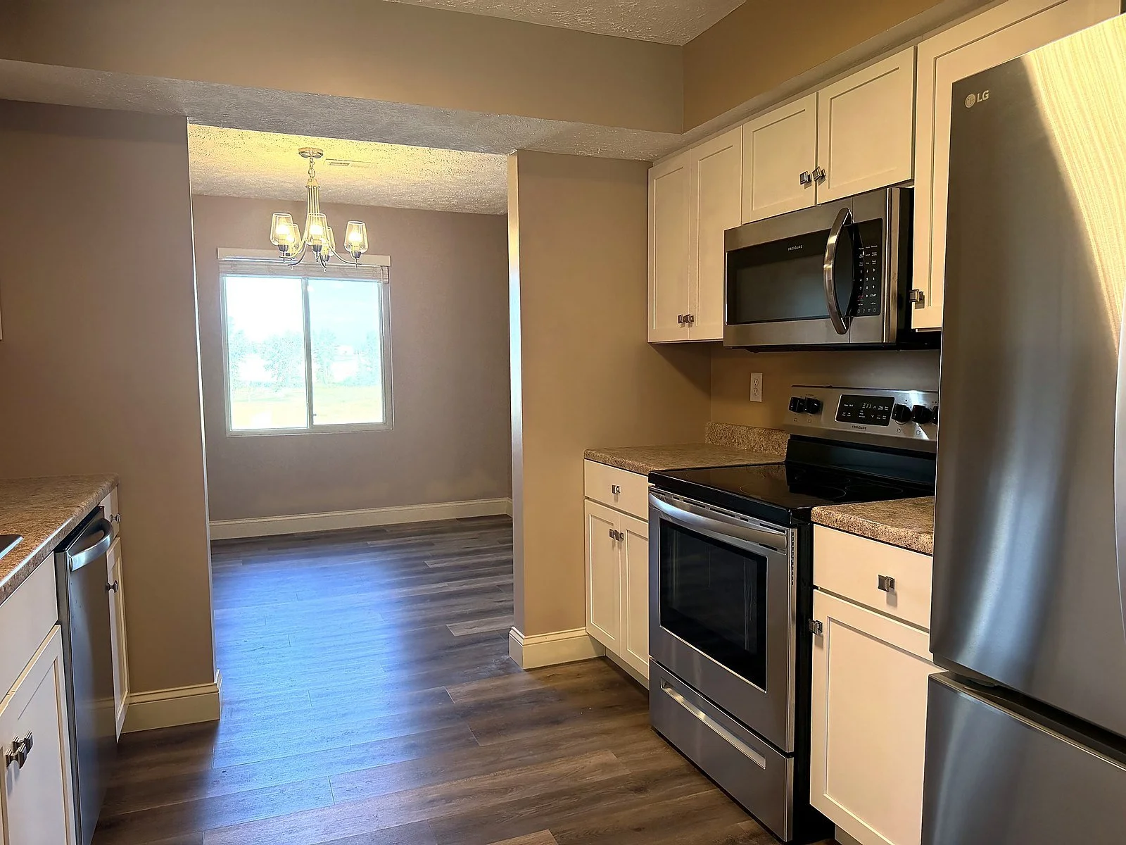 Kitchen with white cabinets, granite counters and stainless appliances
